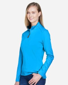 Devon & Jones DG479W Women’s DRYTEC20™ Performance Quarter-Zip Pullover – Ocean Blue/ Navy/ Ocean Blue (on model side)