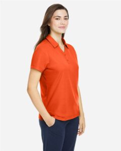CORE365 CE112W Women’s Fusion ChromaSoft™ Pique Polo – Campus Orange (on model side)