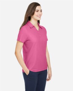 CORE365 CE112W Women’s Fusion ChromaSoft™ Pique Polo – Charity Pink (on model side)