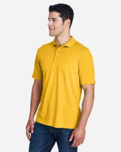 CORE365 88181 Men’s Origin Performance Piqué Polo – Campus Gold (on model side)