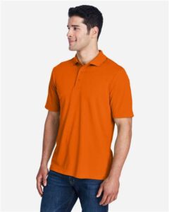 CORE365 88181 Men’s Origin Performance Piqué Polo – Campus Orange (on model side)