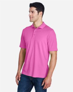CORE365 88181 Men’s Origin Performance Piqué Polo – Charity Pink (on model side)
