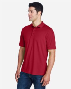 CORE365 88181 Men’s Origin Performance Piqué Polo – Classic Red (on model side)