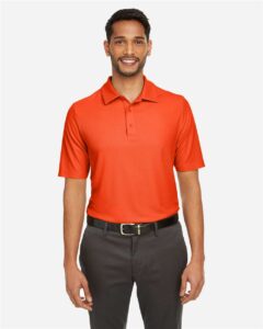 CORE365 CE112 Men’s Fusion ChromaSoft™ Pique Polo – Campus Orange (on model)