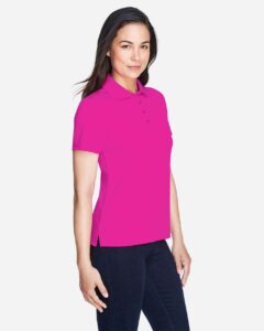 CORE365 78181 Women’s Origin Performance Piqué Polo – Bright Magenta (on model side)