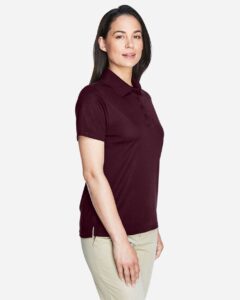 CORE365 78181 Women’s Origin Performance Piqué Polo – Burgundy (on model side)