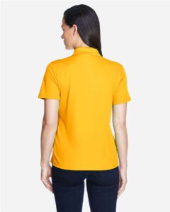 CORE365 78181 Women’s Origin Performance Piqué Polo – Campus Gold (on model back)