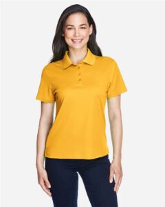 CORE365 78181 Women’s Origin Performance Piqué Polo – Campus Gold (on model)