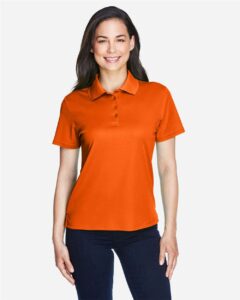 CORE365 78181 Women’s Origin Performance Piqué Polo – Campus Orange (on model)