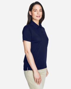 CORE365 78181 Women’s Origin Performance Piqué Polo – Classic Navy (on model side)