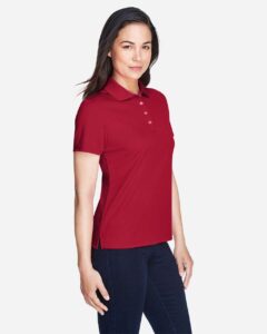 CORE365 78181 Women’s Origin Performance Piqué Polo – Classic Red (on model side)