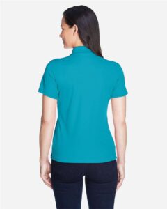 CORE365 78181 Women’s Origin Performance Piqué Polo – Clear Teal (on model back)