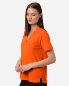 CORE365 CE106W Women’s Resolve CVC Performance Pique Polo – Campus Orange (on model side)