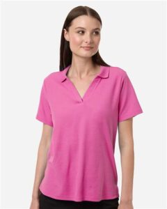 CORE365 CE106W Women’s Resolve CVC Performance Pique Polo – Charity Pink (on model)