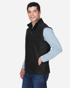 CORE365 88191 Men’s Journey Fleece Vest – Black (on model side)