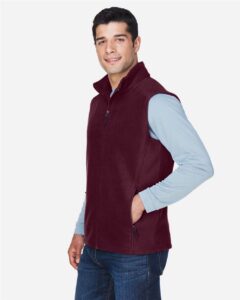 CORE365 88191 Men’s Journey Fleece Vest – Burgundy (on model side)