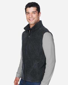 CORE365 88191 Men’s Journey Fleece Vest – Heather Charcoal (on model side)
