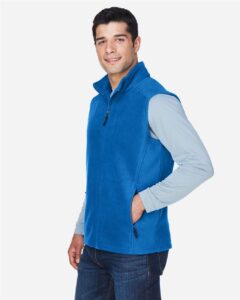 CORE365 88191 Men’s Journey Fleece Vest – True Royal (on model side)