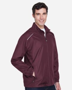 CORE365 88183 Men’s Techno Lite Motivate Unlined Lightweight Jacket – Burgundy (on model side)