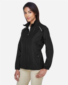 CORE365 78183 Women’s Techno Lite Motivate Unlined Lightweight Jacket – Black (on model side)