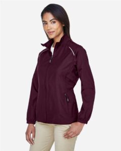 CORE365 78183 Women’s Techno Lite Motivate Unlined Lightweight Jacket – Burgundy (on model side)