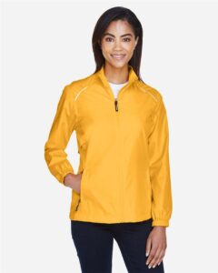 CORE365 78183 Women’s Techno Lite Motivate Unlined Lightweight Jacket – Campus Gold (on model)