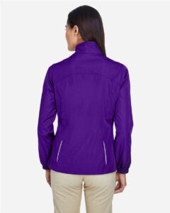 CORE365 78183 Women’s Techno Lite Motivate Unlined Lightweight Jacket – Campus Purple (on model back)