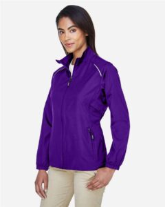 CORE365 78183 Women’s Techno Lite Motivate Unlined Lightweight Jacket – Campus Purple (on model side)