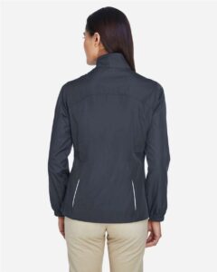CORE365 78183 Women’s Techno Lite Motivate Unlined Lightweight Jacket – Carbon (on model back)