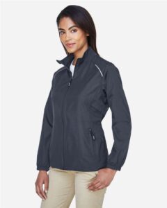 CORE365 78183 Women’s Techno Lite Motivate Unlined Lightweight Jacket – Carbon (on model side)