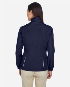 CORE365 78183 Women’s Techno Lite Motivate Unlined Lightweight Jacket – Classic Navy (on model back)