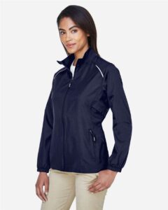 CORE365 78183 Women’s Techno Lite Motivate Unlined Lightweight Jacket – Classic Navy (on model side)
