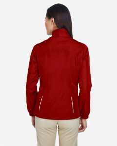 CORE365 78183 Women’s Techno Lite Motivate Unlined Lightweight Jacket – Classic Red (on model back)