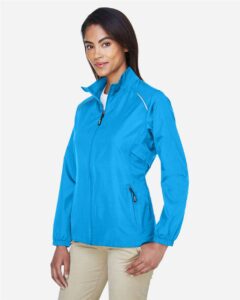 CORE365 78183 Women’s Techno Lite Motivate Unlined Lightweight Jacket – Electric Blue (on model side)