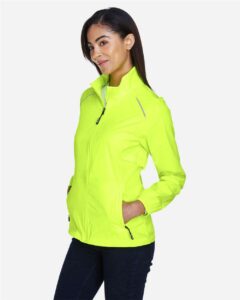 CORE365 78183 Women’s Techno Lite Motivate Unlined Lightweight Jacket – Safety Yellow (on model side)