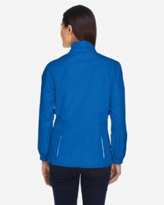 CORE365 78183 Women’s Techno Lite Motivate Unlined Lightweight Jacket – True Royal (on model back)