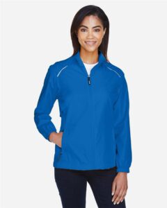 CORE365 78183 Women’s Techno Lite Motivate Unlined Lightweight Jacket – True Royal (on model)