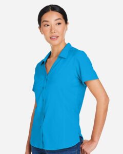 CORE365 CE510W Women’s Ultra UVP® Marina Shirt – Electric Blue (on model side)