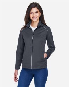 CORE365 CE708W Women’s Techno Lite Three-Layer Knit Tech-Shell – Carbon (on model)