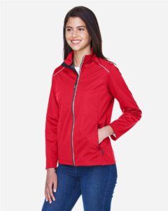 CORE365 CE708W Women’s Techno Lite Three-Layer Knit Tech-Shell – Classic Red (on model side)