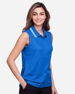 Devon & Jones DG20SW Women’s CrownLux Performance® Plaited Tipped Sleeveless Polo – French Blue/ White (on model side)
