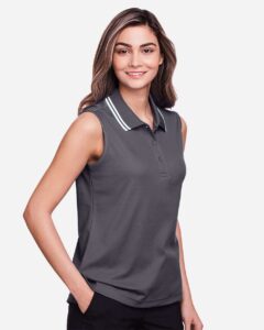 Devon & Jones DG20SW Women’s CrownLux Performance® Plaited Tipped Sleeveless Polo – Graphite/ White (on model side)