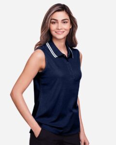 Devon & Jones DG20SW Women’s CrownLux Performance® Plaited Tipped Sleeveless Polo – Navy/ White (on model side)