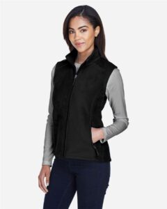 CORE365 78191 Women’s Journey Fleece Vest – Black (on model side)