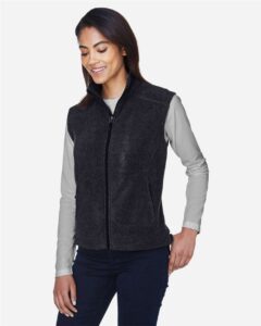 CORE365 78191 Women’s Journey Fleece Vest – Heather Charcoal (on model side)