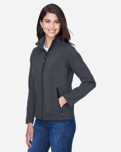 CORE365 78184 Women’s Cruise Two-Layer Fleece Bonded Soft Shell Jacket – Carbon (on model side)