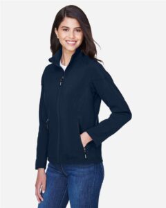 CORE365 78184 Women’s Cruise Two-Layer Fleece Bonded Soft Shell Jacket – Classic Navy (on model side)
