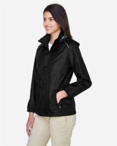 CORE365 78185 Women’s Climate Seam-Sealed Lightweight Variegated Ripstop Jacket – Black (on model side)