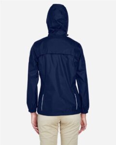 CORE365 78185 Women’s Climate Seam-Sealed Lightweight Variegated Ripstop Jacket – Classic Navy (on model back)