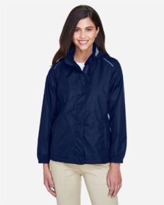 CORE365 78185 Women’s Climate Seam-Sealed Lightweight Variegated Ripstop Jacket – Classic Navy (on model)